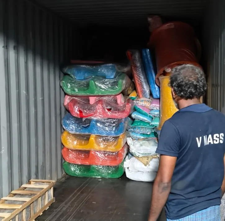 Team member stacking packed cargo inside a container