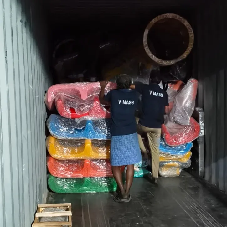 Two DLE Global team members stuffing a container